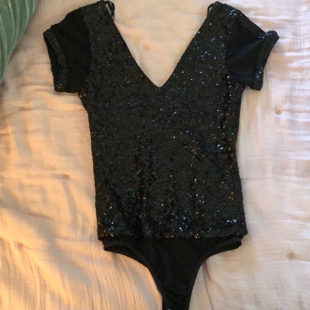 Black sequin body suit .